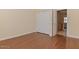 Bedroom with hardwood floors, closet, and open doorway to the bathroom at 15806 N 107Th Pl, Scottsdale, AZ 85255
