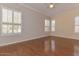 Bedroom featuring a ceiling fan, hardwood floors, and bright windows at 15806 N 107Th Pl, Scottsdale, AZ 85255