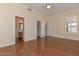 This bedroom has hardwood floors with an ensuite bathroom, closet, and natural light at 15806 N 107Th Pl, Scottsdale, AZ 85255