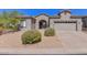 Inviting single-story home with a well-maintained desert landscape and a two-car garage at 15806 N 107Th Pl, Scottsdale, AZ 85255