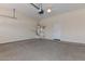 Clean garage featuring an open space with sink, water heater, and concrete floor at 15806 N 107Th Pl, Scottsdale, AZ 85255