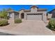 Beige home with a two car garage and driveway featuring desert landscaping at 15806 N 107Th Pl, Scottsdale, AZ 85255