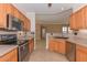 Kitchen features light cabinets, stainless steel appliances, and view into the living area at 15806 N 107Th Pl, Scottsdale, AZ 85255
