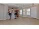 Bright living space with tiled floors, kitchen bar seating, and natural lighting from shuttered windows at 15806 N 107Th Pl, Scottsdale, AZ 85255