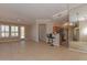 Spacious open living area with tiled floors, pendant lighting, and seamless flow into the kitchen at 15806 N 107Th Pl, Scottsdale, AZ 85255