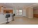 Open concept living area with bar seating, tile flooring, and lots of natural light at 15806 N 107Th Pl, Scottsdale, AZ 85255