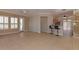 Living room featuring neutral walls, tile floors, and barstool seating at 15806 N 107Th Pl, Scottsdale, AZ 85255