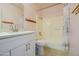 Bathroom with updated vanity, toilet, mirror, and shower/bathtub combo at 1726 W Claremont St, Phoenix, AZ 85015