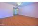 Bedroom with neutral colors, laminate flooring, ceiling fan, and a view into the hallway at 1726 W Claremont St, Phoenix, AZ 85015