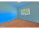 Bedroom with wood-look floors, large window and overhead lighting at 1726 W Claremont St, Phoenix, AZ 85015