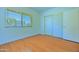Bedroom featuring a large window and closet doors with wood-look floors at 1726 W Claremont St, Phoenix, AZ 85015