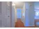 Hallway featuring multiple closets and an open floor plan layout with wood-look floors at 1726 W Claremont St, Phoenix, AZ 85015