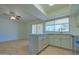 Open concept kitchen with white cabinets, stainless steel appliances, breakfast bar, and a view to the dining area at 1726 W Claremont St, Phoenix, AZ 85015