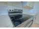 Close-up of stainless steel stove and light countertops with a subway tile backsplash at 1726 W Claremont St, Phoenix, AZ 85015
