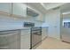 Well-lit kitchen showcasing stainless steel appliances, light countertops, subway tile backsplash, and ample storage space at 1726 W Claremont St, Phoenix, AZ 85015