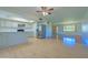 Open floor plan showcasing a spacious kitchen with stainless steel refrigerator and breakfast bar, with a view to the entry at 1726 W Claremont St, Phoenix, AZ 85015