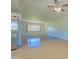 Open floor plan with laminate wood flooring, ceiling fan, and bright window at 1726 W Claremont St, Phoenix, AZ 85015
