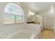 Bright bathroom with a soaking tub and tiled walk-in shower at 1741 S Clearview Ave # 74, Mesa, AZ 85209