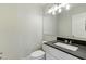Modern half bathroom with a gray countertop, white cabinets, and a large mirror above the sink at 1741 S Clearview Ave # 74, Mesa, AZ 85209