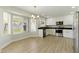 Modern kitchen with white cabinets, stainless steel appliances, a large window and wood-style flooring at 1741 S Clearview Ave # 74, Mesa, AZ 85209