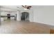 Bright open-concept living area with wood-style flooring connecting the kitchen and staircase to the upper level at 1741 S Clearview Ave # 74, Mesa, AZ 85209