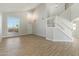 Bright, open living room with wood-style tile flooring and a staircase leading to the second floor at 1741 S Clearview Ave # 74, Mesa, AZ 85209