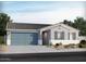 Charming single-story home with a gray facade, a two-car garage, and desert landscaping at 17733 W Ford St, Goodyear, AZ 85338