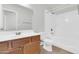 Well-lit bathroom with a wood vanity, generous mirror and a tub-shower combo at 1811 S 39Th St # 30, Mesa, AZ 85206