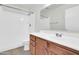 Clean bathroom with wooden vanity, sink, and shower with solid surface walls at 1811 S 39Th St # 30, Mesa, AZ 85206