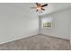 Bare bedroom featuring a window for natural light, carpeted floors, and a ceiling fan at 1811 S 39Th St # 30, Mesa, AZ 85206