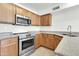 Bright kitchen features stainless steel appliances, ample cabinetry, and neutral granite countertops at 1811 S 39Th St # 30, Mesa, AZ 85206