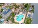 An aerial view shows a sparkling pool and spa with ample seating, nestled within lush greenery at 1811 S 39Th St # 30, Mesa, AZ 85206
