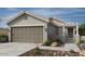 Charming single-Gathering home with a two-car garage, landscaped front yard, and inviting front porch at 18540 N Foxtail Dr, Maricopa, AZ 85138
