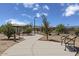Community park walkway with benches and shade, inviting residents to relax and enjoy the outdoors at 18540 N Foxtail Dr, Maricopa, AZ 85138
