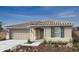 Charming single-story home with a neutral color scheme, arched entryway, and well-manicured landscaping at 21167 E Arrowhead Trl, Queen Creek, AZ 85142