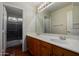 Bathroom features a double sink vanity, tile floors and a shower and tub at 21614 N 59Th Ln, Glendale, AZ 85308