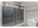 Bathroom featuring a shower and tub with sliding glass door, and tile flooring at 21614 N 59Th Ln, Glendale, AZ 85308
