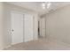 Bedroom with closet doors and a view into the adjacent room at 21614 N 59Th Ln, Glendale, AZ 85308