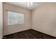 Simple bedroom featuring neutral walls, carpet, and a window with blinds at 21614 N 59Th Ln, Glendale, AZ 85308
