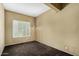Relaxing bedroom with a light fixture, neutral walls, plush carpeting and bright window at 21614 N 59Th Ln, Glendale, AZ 85308