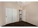 Bedroom with closet doors and a view into the laundry room at 21614 N 59Th Ln, Glendale, AZ 85308