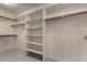 Spacious walk-in closet with ample shelving and hanging space at 21614 N 59Th Ln, Glendale, AZ 85308
