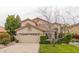 Two-story stucco home with a tile roof, a two car garage, and mature landscaping at 21614 N 59Th Ln, Glendale, AZ 85308