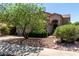 Attractive home showcasing a welcoming entrance, complemented by mature trees and beautifully landscaped surroundings at 21614 N 59Th Ln, Glendale, AZ 85308