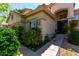 Inviting home exterior with lush landscaping, a tile roof, and charming architectural details for a warm welcome at 21614 N 59Th Ln, Glendale, AZ 85308
