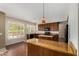 Bright kitchen featuring hardwood floors, center island with stone countertops and stainless steel appliances at 21614 N 59Th Ln, Glendale, AZ 85308