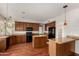 Bright kitchen featuring hardwood floors, center island with stone countertops and stainless steel appliances at 21614 N 59Th Ln, Glendale, AZ 85308