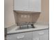 Small laundry room has a sink, cabinets and a light colored countertop at 21614 N 59Th Ln, Glendale, AZ 85308