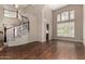 Bright living room featuring a staircase with white railings and large windows with white shutters at 21614 N 59Th Ln, Glendale, AZ 85308