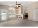 Spacious living room featuring a ceiling fan, built-in shelving, and natural light at 21614 N 59Th Ln, Glendale, AZ 85308